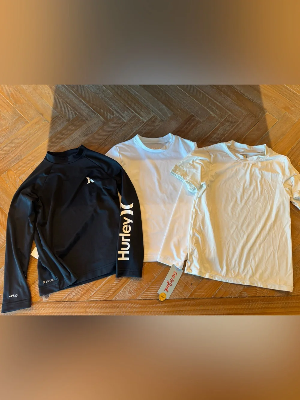 Hurley Black Long Sleeve Rash Guard, White Cat & Jack Long Sleeve Rash Gard, and